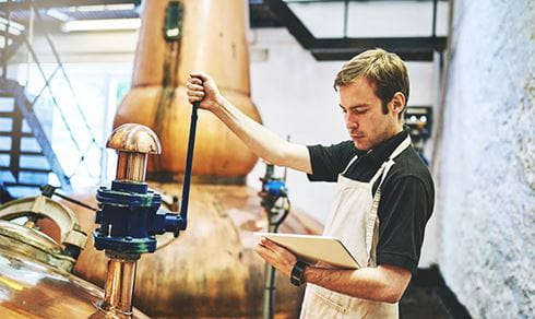 A man working in a beer distillery