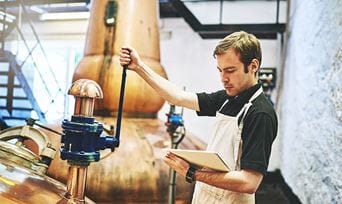 A man working in a beer distillery