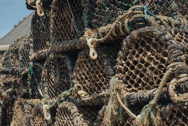 A stack of crab traps in a harbour in Cornwall