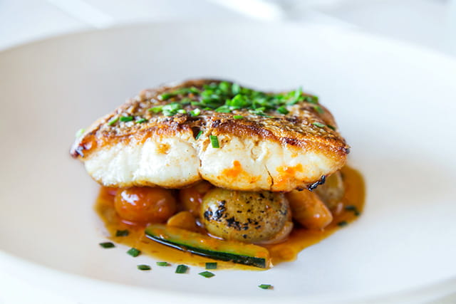 A dish with pan fried sea bass