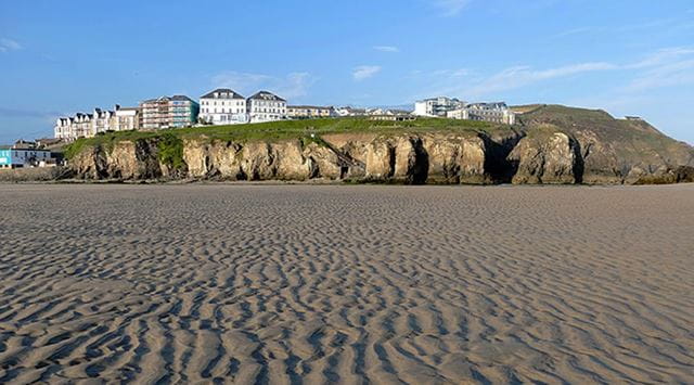 beach and cliffs with houses on the clifftop