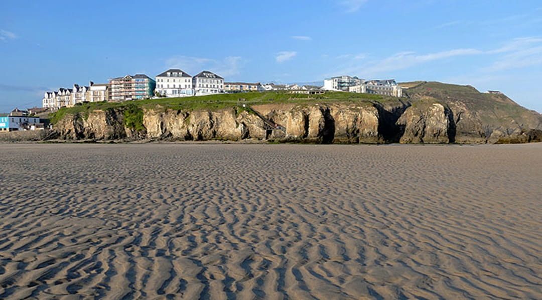 beach and cliffs with houses on the clifftop