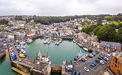 A busy fishing harbour full of boats in Padstow Cornwall