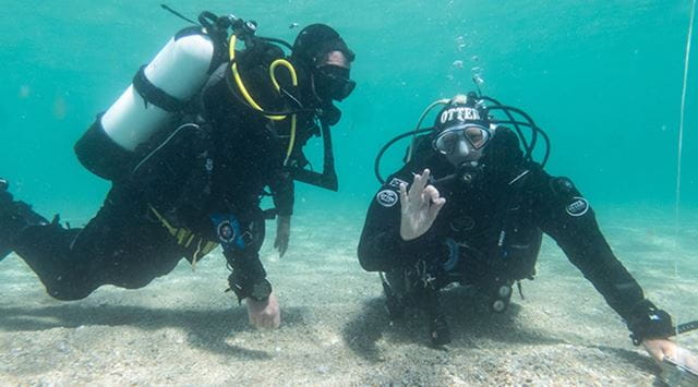 two scuba divers giving the ok symbol