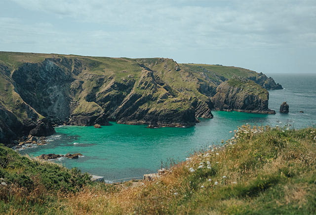 A spectacular view over a cove on the Cornish coast on a warm day