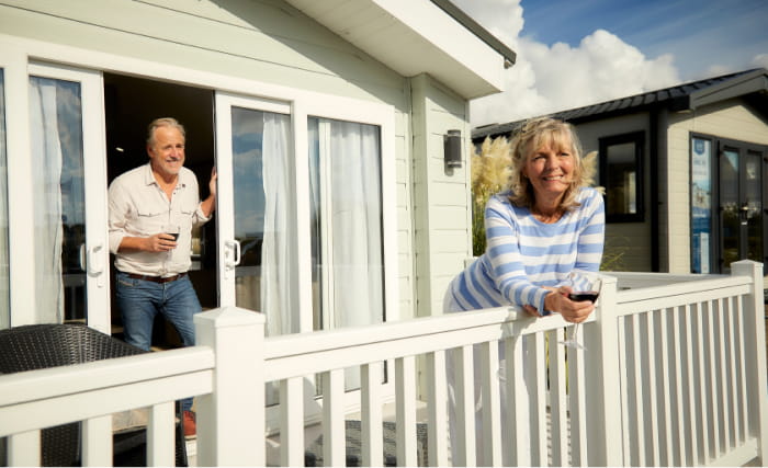 Couple relaxing outside their static caravan