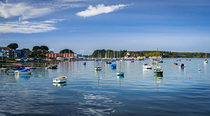 boats moored within a calm harbour at Poole