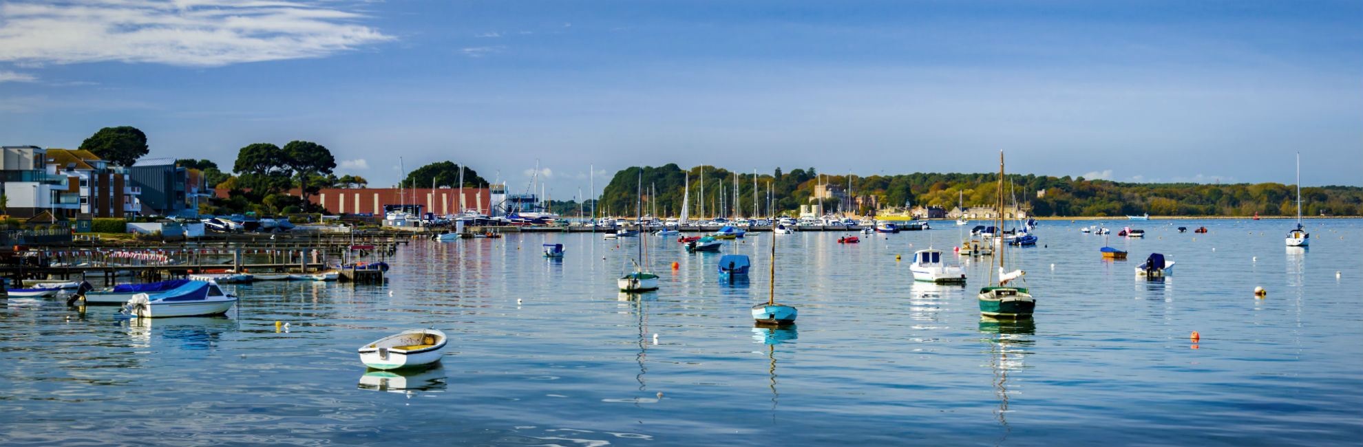 boats moored within a calm harbour at Poole