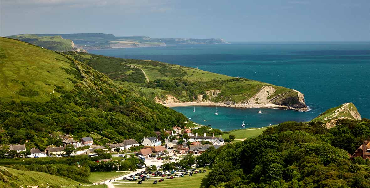 A view over Lulworth Cove and the Dorset Coast on a summer day