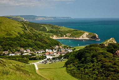 A view over Lulworth Cove and the Dorset Coast on a summer day