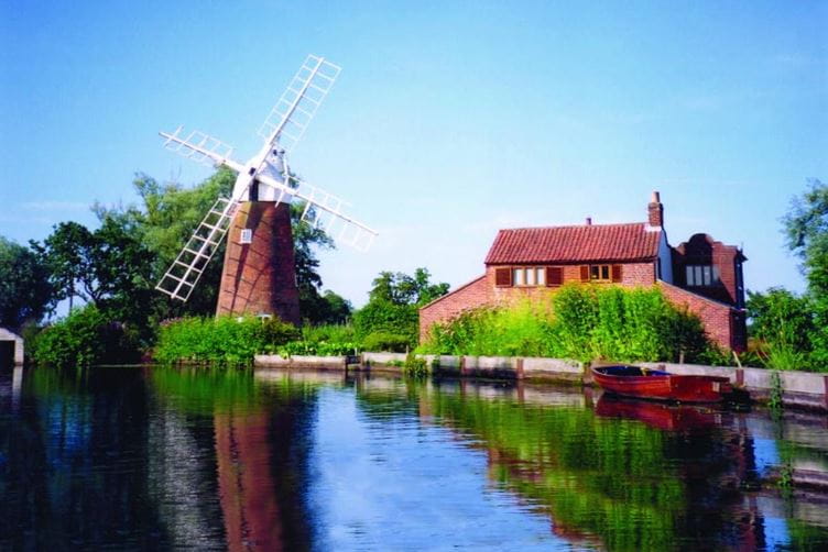Cottage and windmill in the sun
