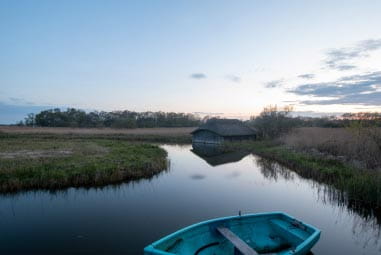 Peaceful lake with wooden boat floating