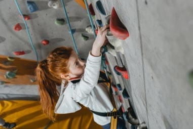 Girl indoor rock climbing