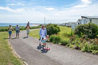 Family walking through Parkdean Resorts
