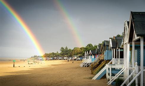 A rainbow over a beach on the Norfolk Coast