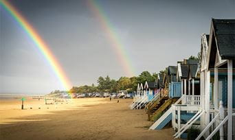 A rainbow over a beach on the Norfolk Coast