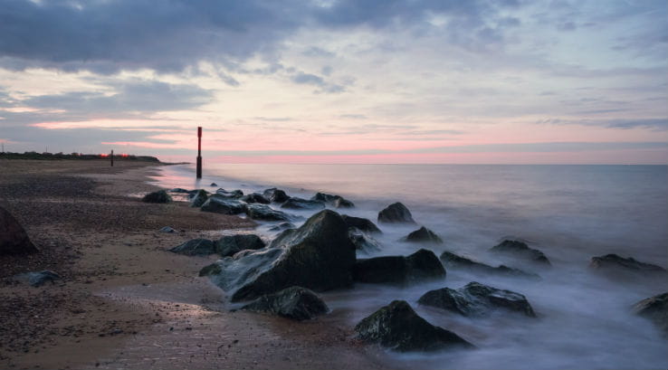 rocks on a beach at sunset