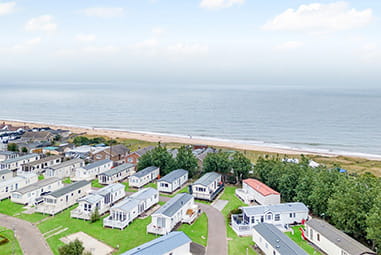 Caravans overlooking the beach at California Cliffs Holiday Park in Norfolk