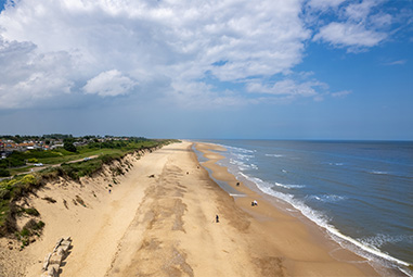 An aerial view over a beach in Norfolk on a sunny day