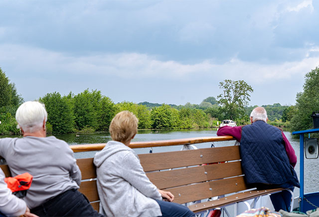Tourists on a boat trip around the Norfolk Broads