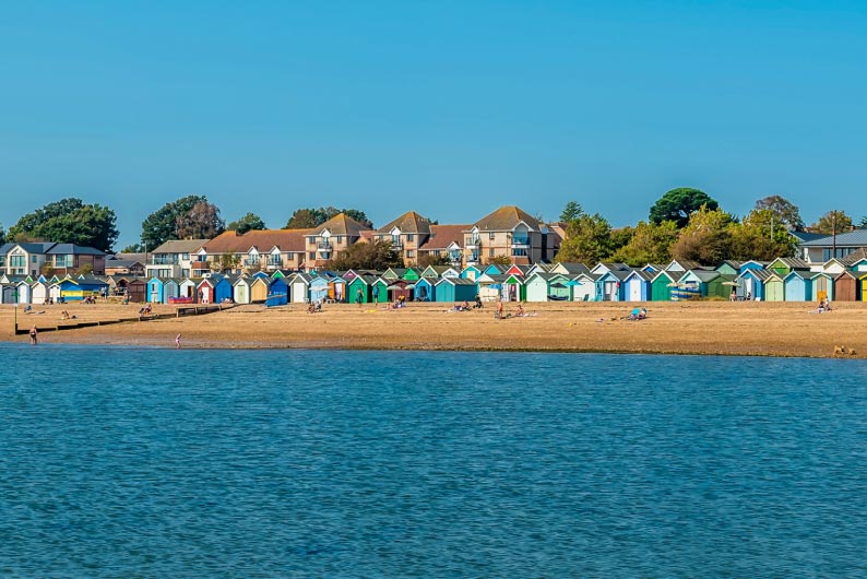 Colourful beach huts on beach in Essex