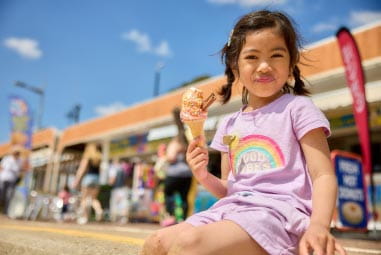 Girl eating ice cream on the beach