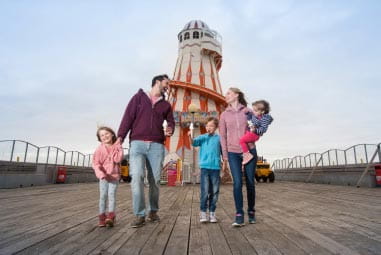 Family walking along the pier