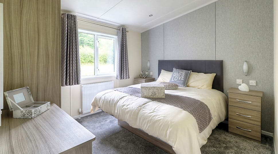 Cosy double bed in a stylish and contemporary lodge