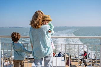 Family standing on ferry