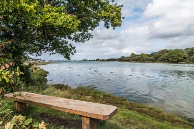 Wooden bench looking onto a lake