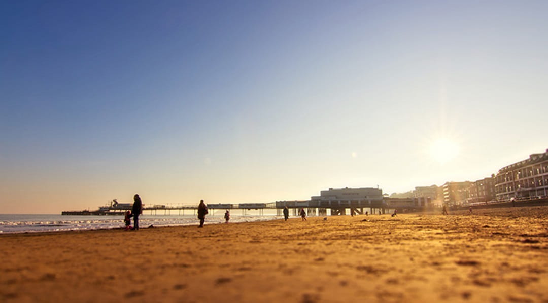 The sun setting over a sandy beach