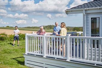 Owners relaxing on the veranda of their holiday home on the Isle of Wight