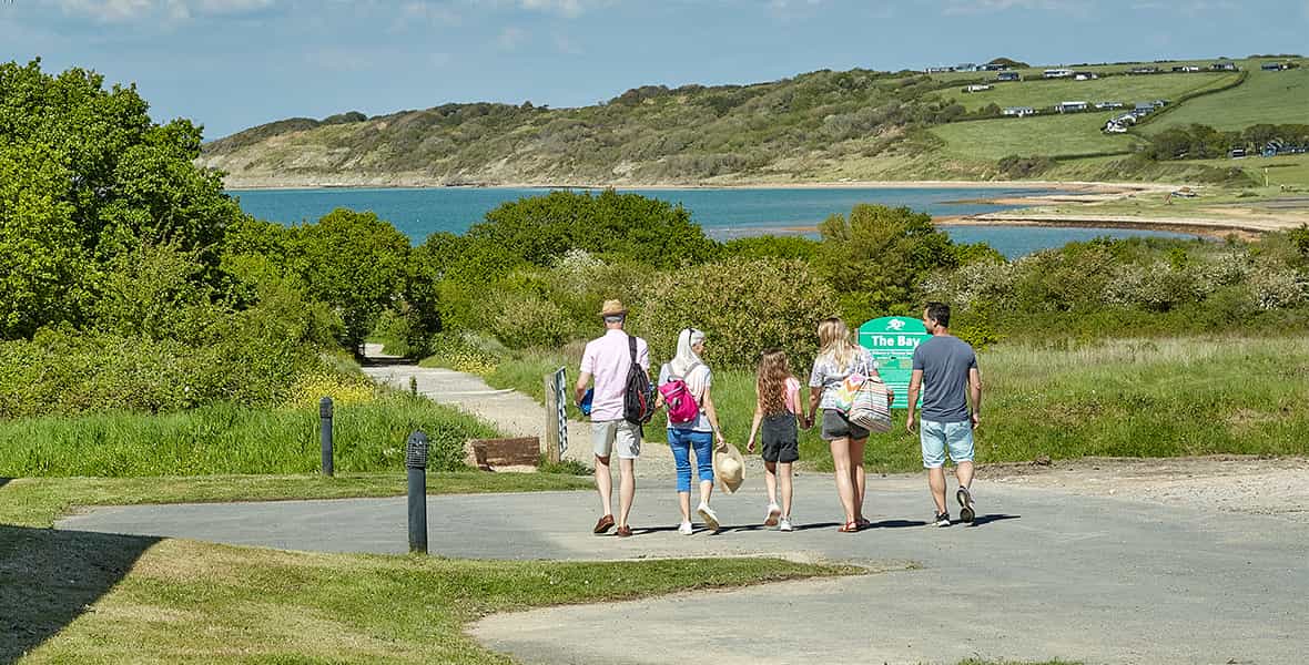 A family walking along the coast on the Isle of Wight