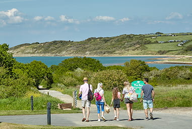 A family walking along the coast on the Isle of Wight