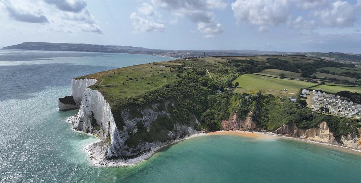 An aerial view of a spectacular white cliff headland on the Isle of Wight on a summer day