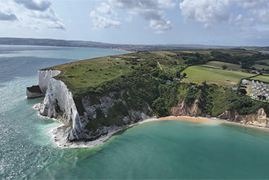 An aerial view of a spectacular white cliff headland on the Isle of Wight on a summer day