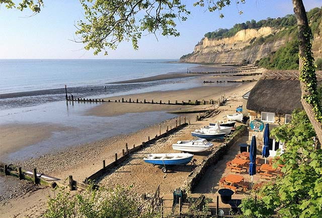Rowing boats lined up on the sand on a beach