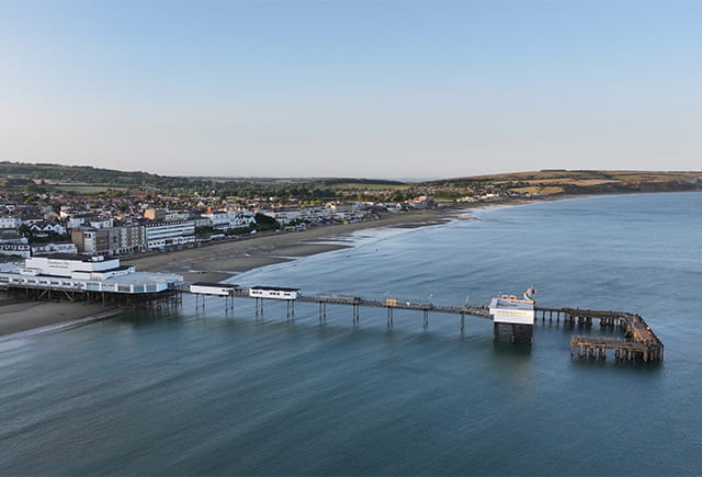 A view over a pier and beach on the Isle of Wight on an Autumn day
