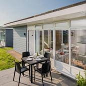 Chalet with table and chairs outside bifolding doors