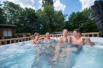 A family enjoying drinks in a hot tub