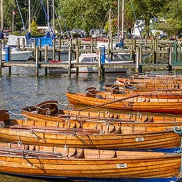 boats lined up on the shore of a lake