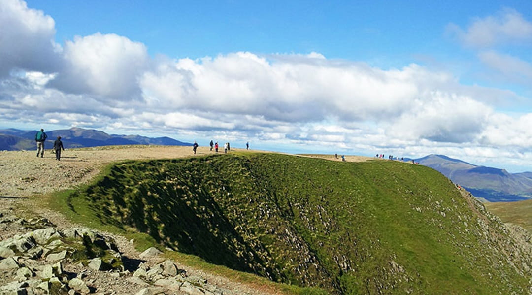 People hiking on the mountains in the Lake District