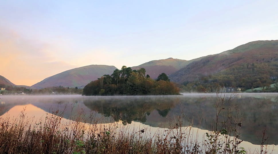 a picturesque view of Grasmere lake with fells in the distance