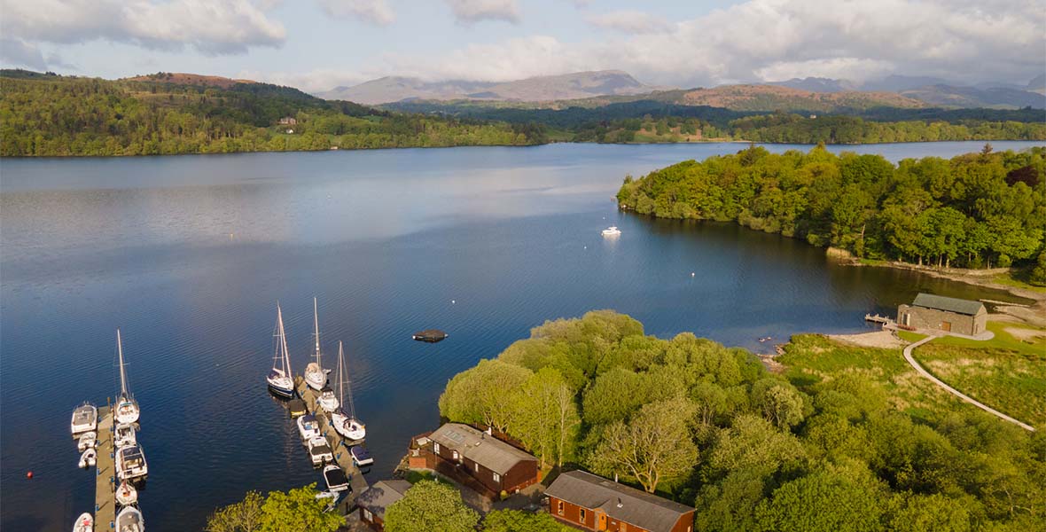 Sailing boats on a jetty overlooking Windermere in the Lake District