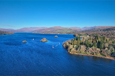 An aerial view over Lake Windermere in the Lake District on a sunny day