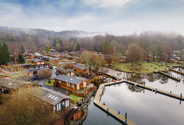 An aerial view over White Cross Bay Holiday Park on the shores of Lake Windermere on an autumn day