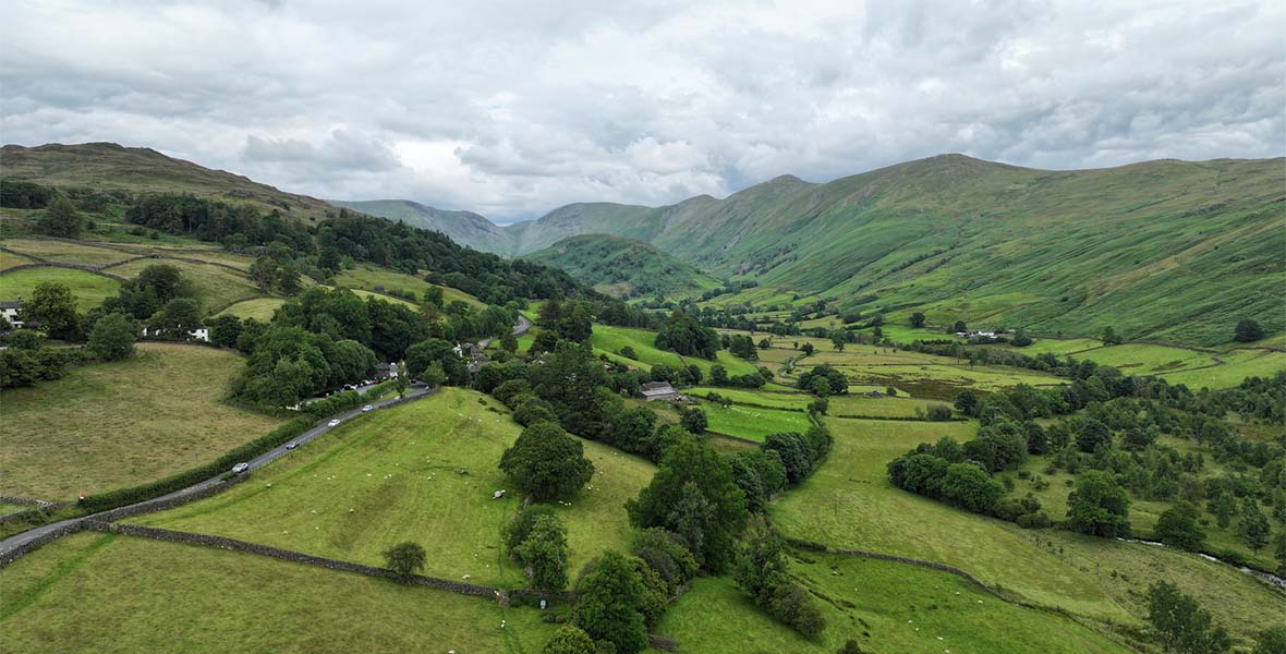 An aerial view of the fields and mountains in the Troutbeck Valley in the Lake District