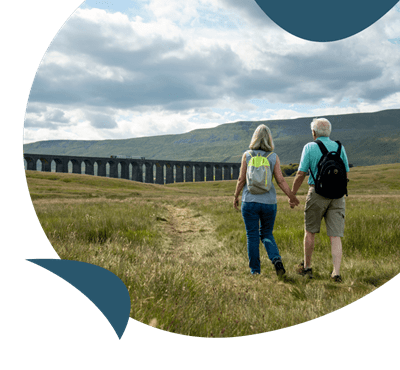 A couple walking across fields