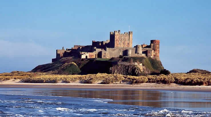 Blue skies over Bamburgh Castle and Beach in Northumberland