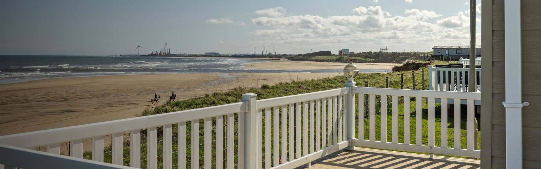 A lodge veranda overlooking the beach at Sandy Bay in Northumberland